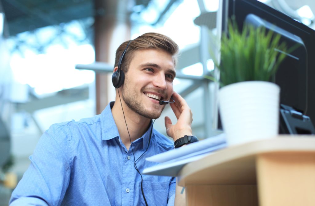 Happy contact centre agent working.