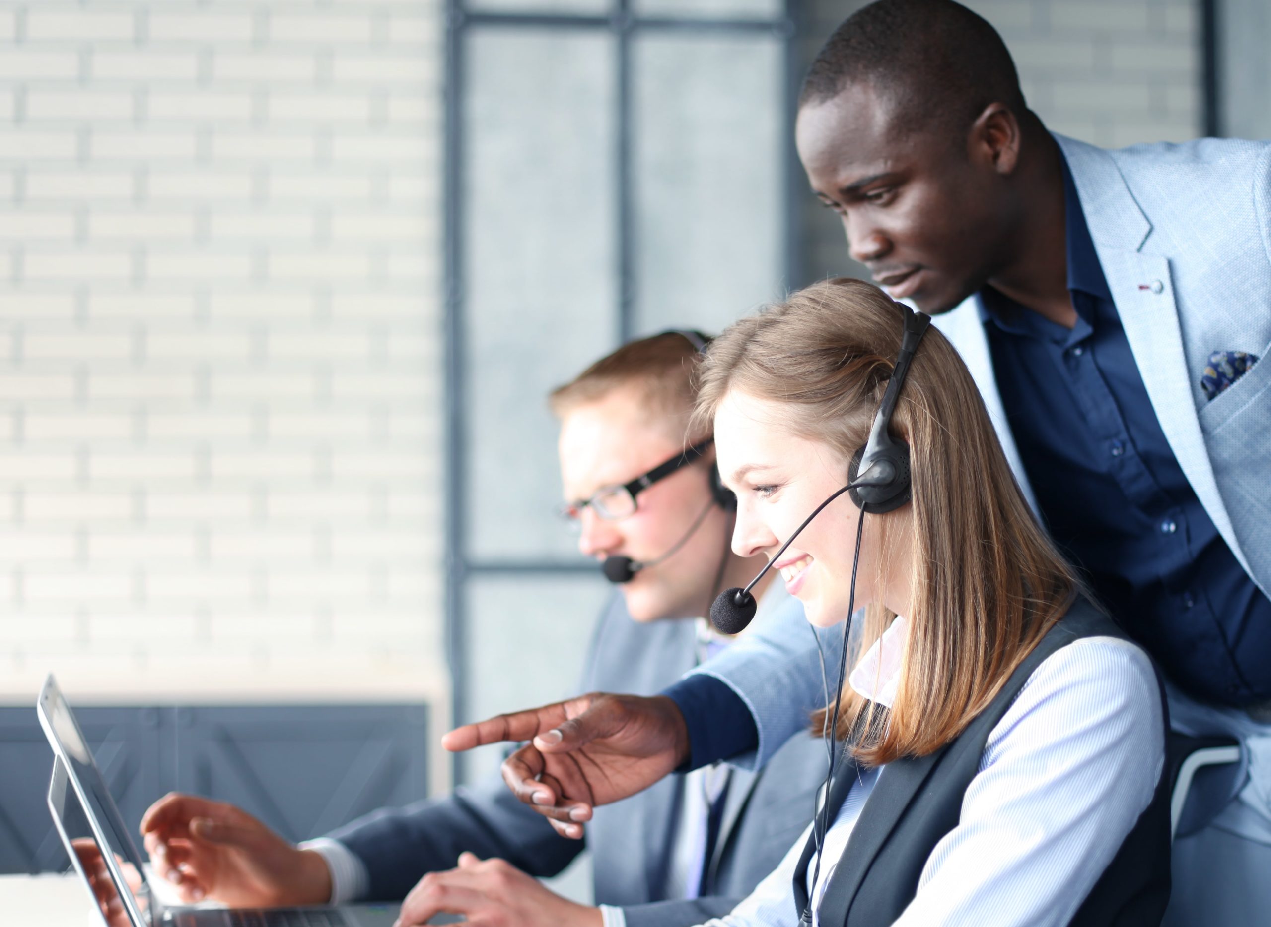 A supervisor training a call centre employee.