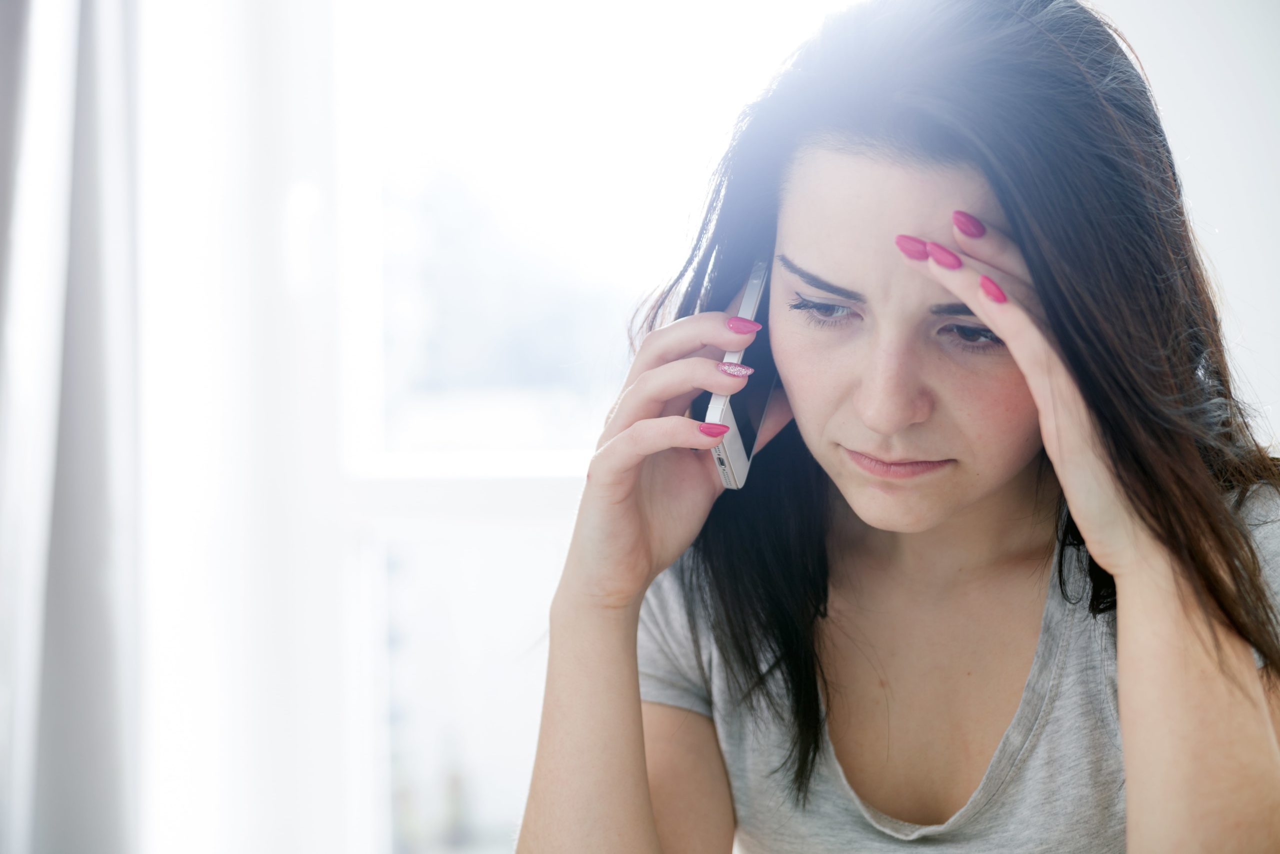 Woman dealing with a nuisance call.