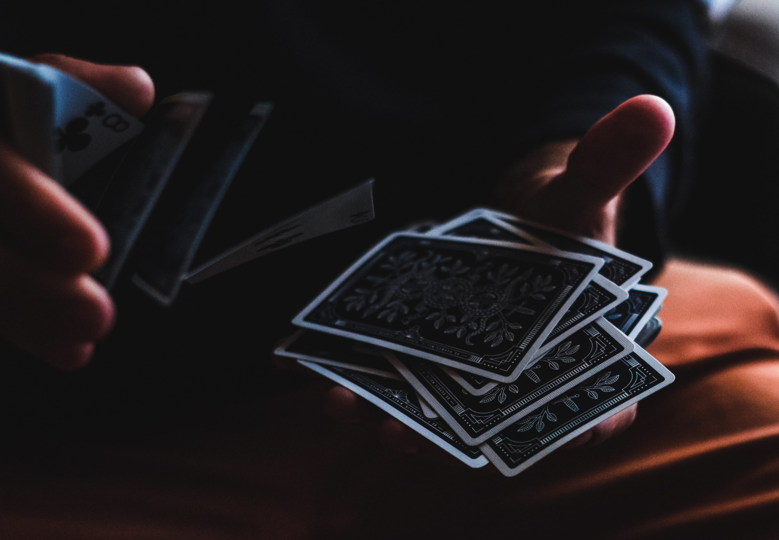 Person shuffling playing cards.